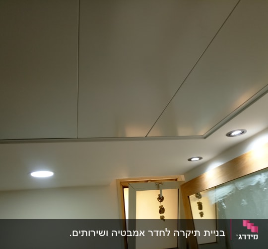 תקרת גבס עם תאורה שקועה ומסגרת עץ